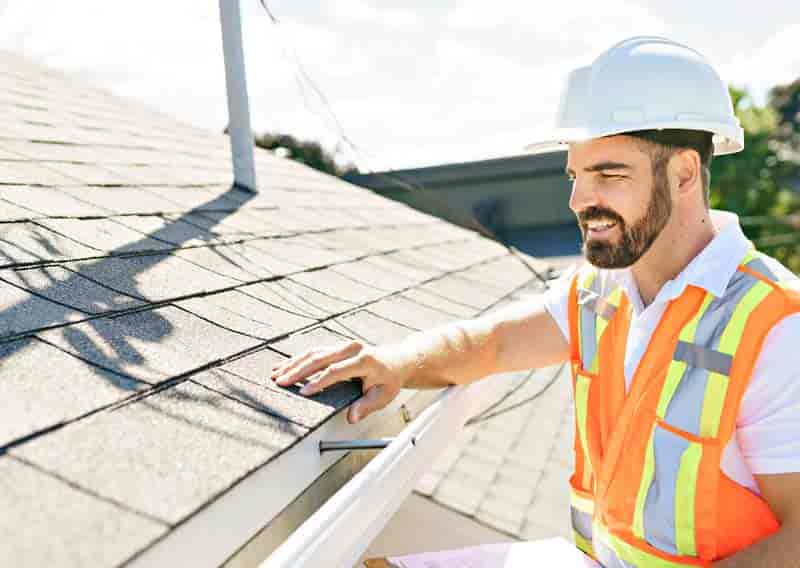 Man inspecting roof.